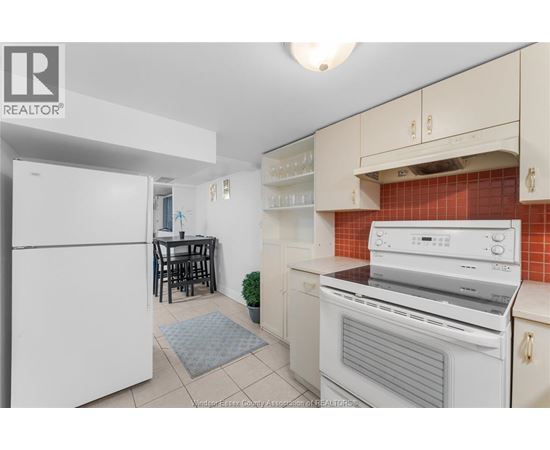 A kitchen with white appliances and a white refrigerator.