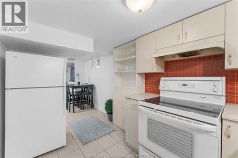 A kitchen with white appliances and a white refrigerator.