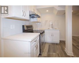 A kitchen with white cabinets and a white countertop.