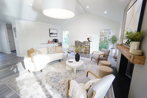 A living room with a white couch and a coffee table.