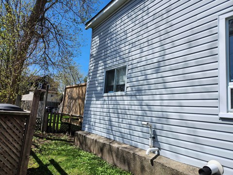 A blue house with a window and a white door.