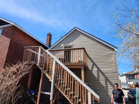 A house with a wooden staircase leading to the second floor.