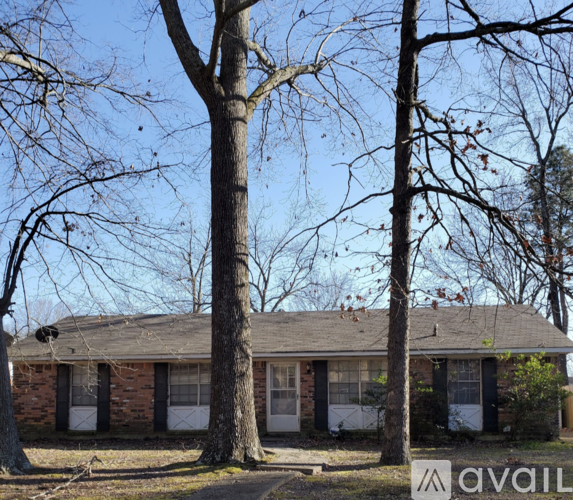 A house with a tree in front of it.