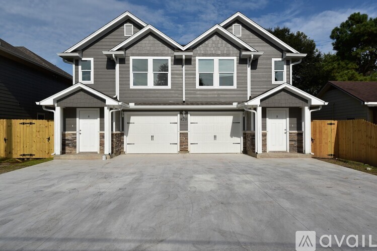 A large house with a grey roof and a garage.