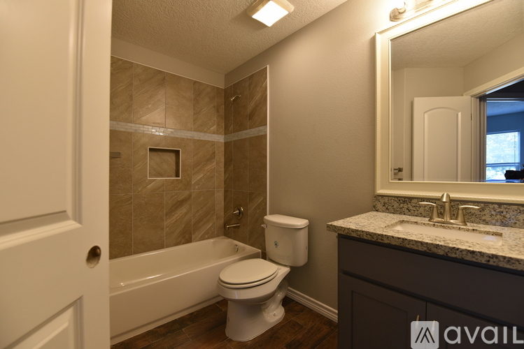 A bathroom with a toilet, sink, and bathtub.