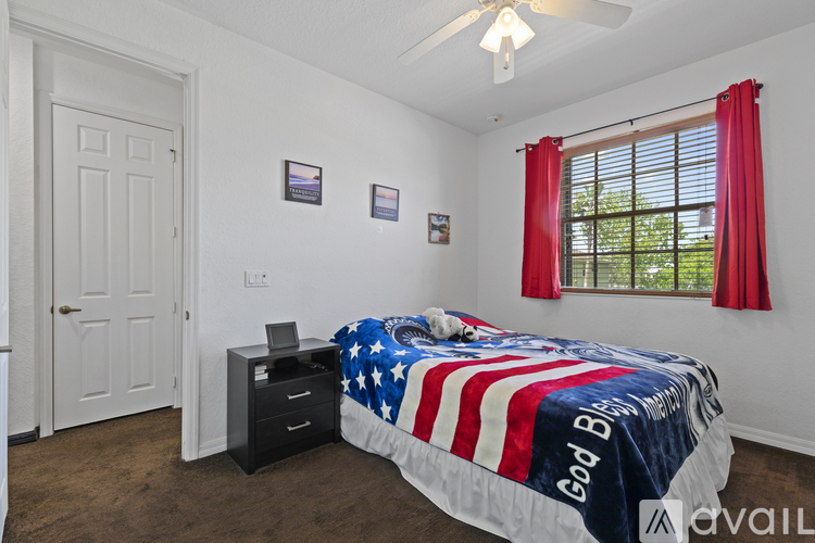 Bedroom with a bed covered in an American flag blanket.