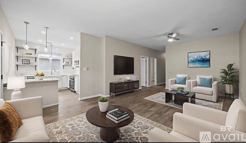A living room with a white couch, a coffee table, and a painting on the wall.