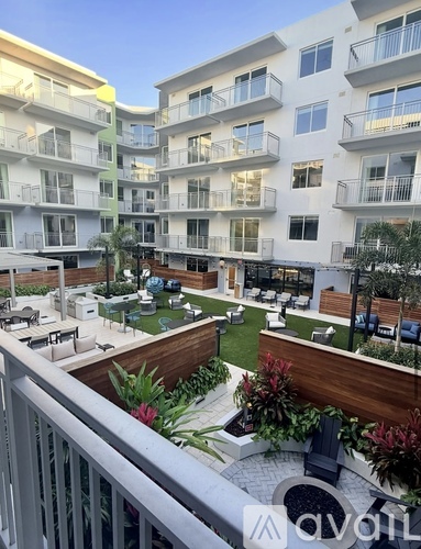 Apartment complex with a small garden in the courtyard.