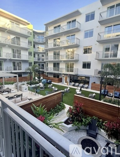 Apartment complex with a small garden in the courtyard.