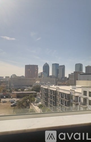 A cityscape with tall buildings and a clear sky.