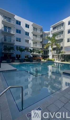 A swimming pool in front of apartment buildings.