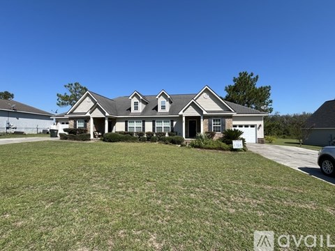 A large house with a well-maintained lawn in front.