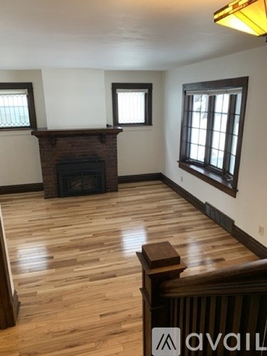 A room with a fireplace and wooden floors.