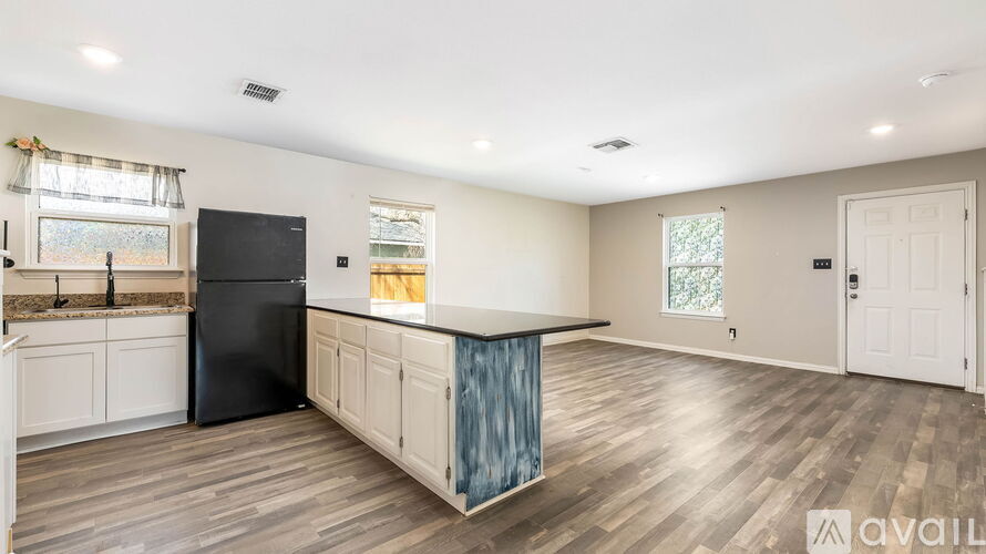 A kitchen with a sink and a window.