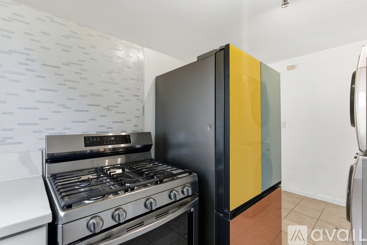 A kitchen with a stove and a refrigerator.