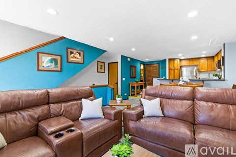 A bedroom with a large bed and a ceiling fan.