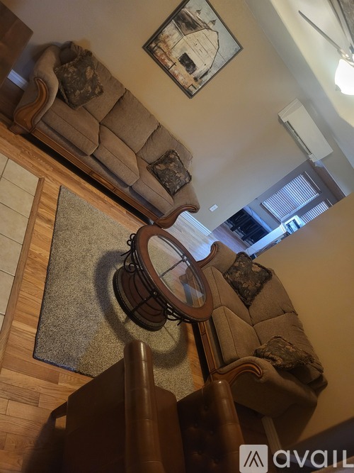 A living room with a couch and a rug.