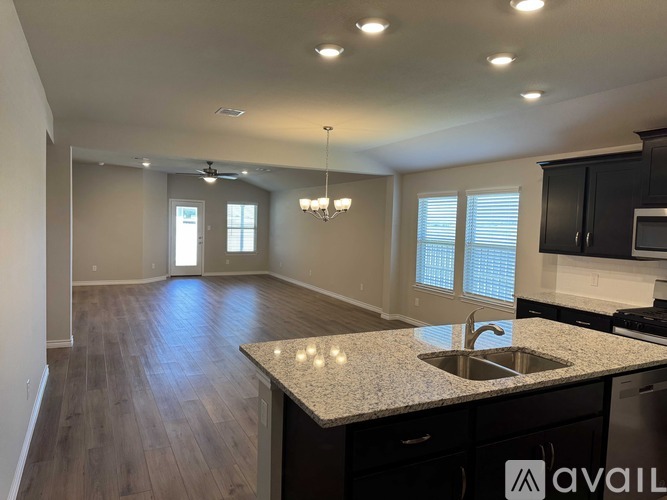 A kitchen with a granite countertop and a sink.
