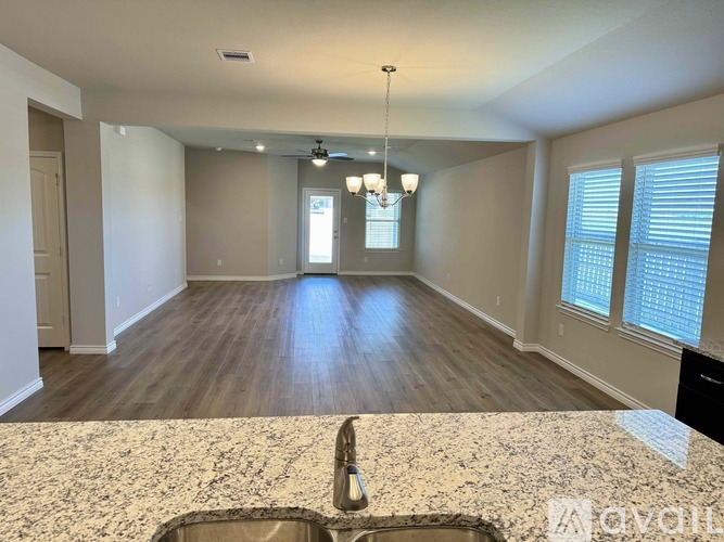 A kitchen with a granite countertop and a sink.