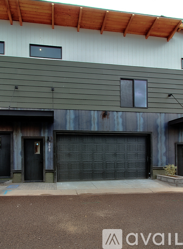 A modern house with a large garage door.