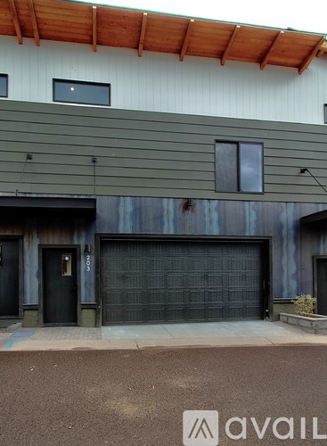 A modern house with a large garage door.