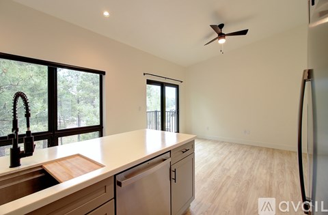 A modern kitchen with a wooden countertop and stainless steel appliances.