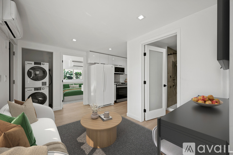 A modern living room with a washing machine and dryer built into the wall.