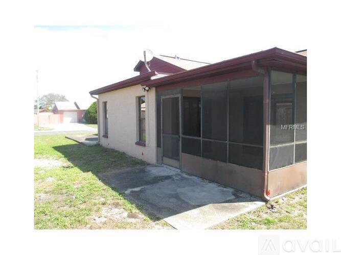 A house with a red roof and a sign that says "For Sale".