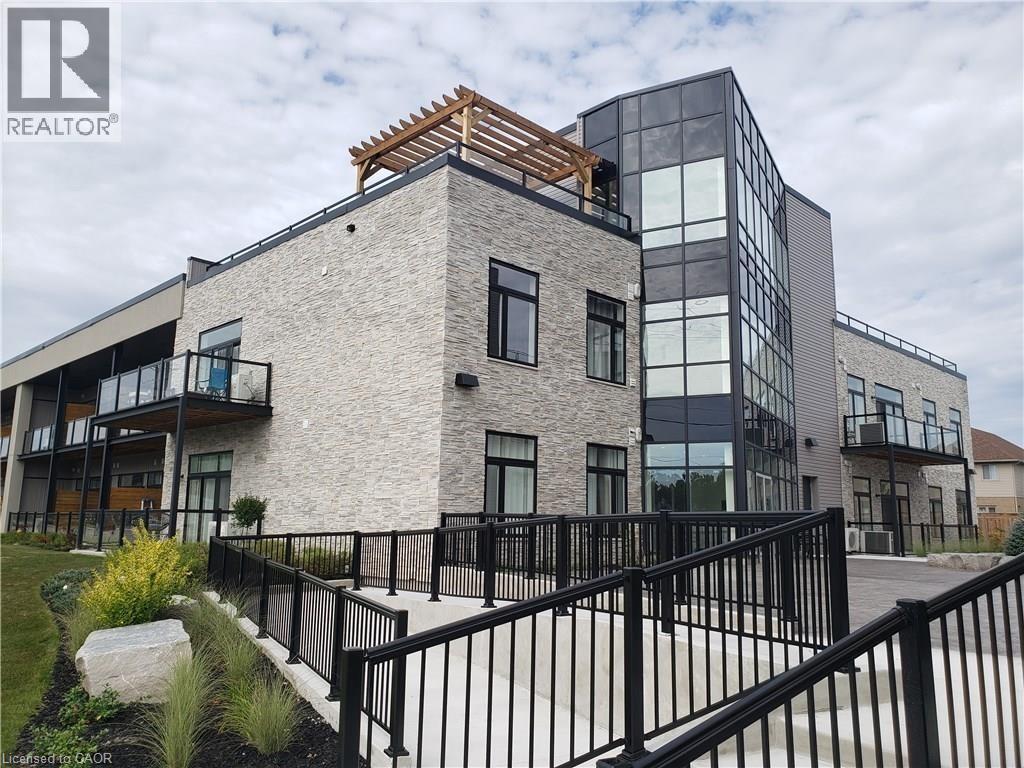 A modern building with a black metal railing in front.