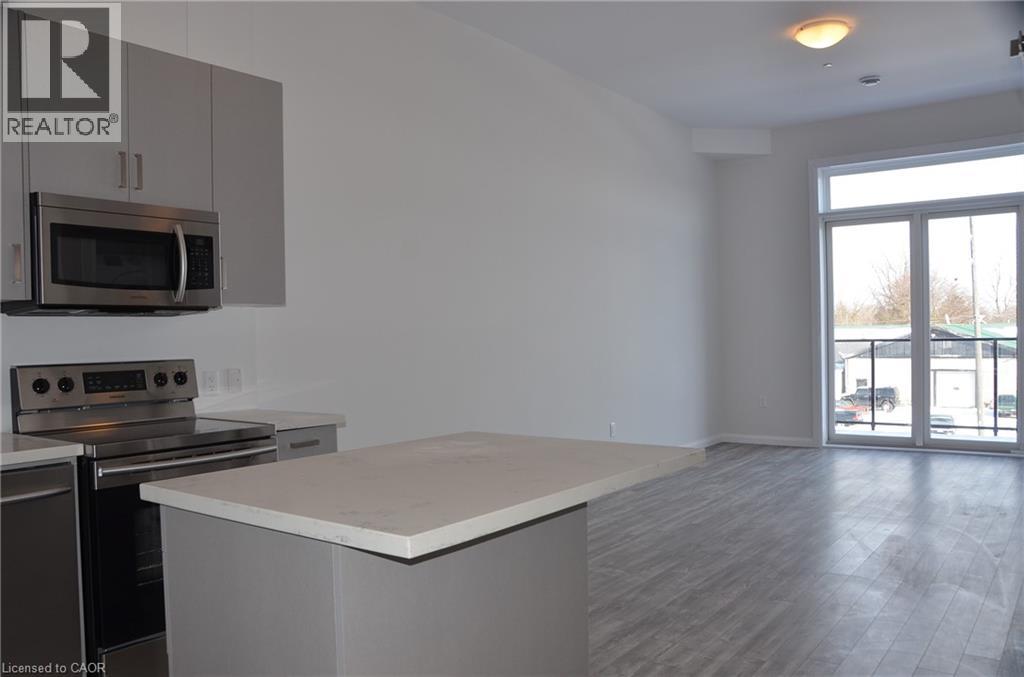 A kitchen with a microwave and oven built into the cabinetry.