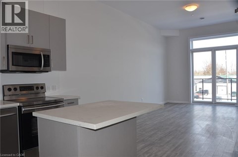 A kitchen with a microwave and oven built into the cabinetry.