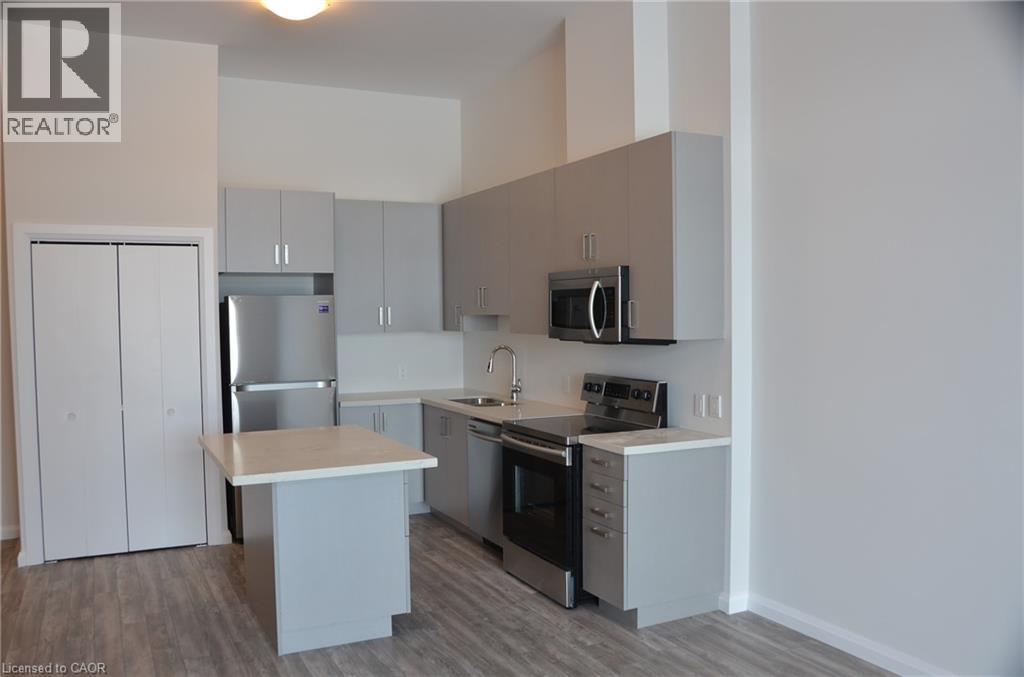 A kitchen with white cabinets and a wooden island.