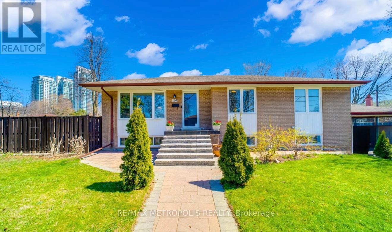 A house with a well-maintained lawn and a clear sky above.