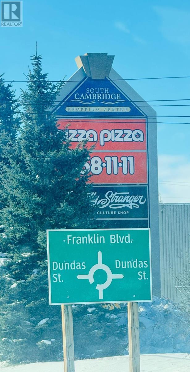 A sign for South Bridge Pizza is displayed on a pole.