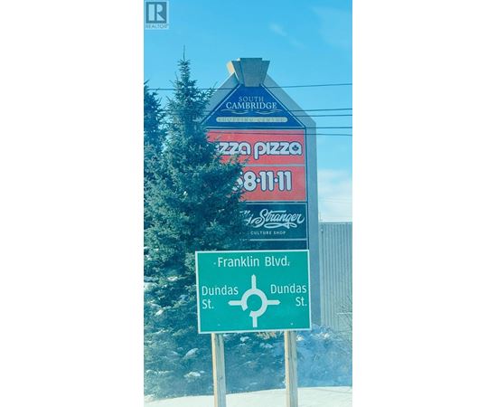 A sign for South Bridge Pizza is displayed on a pole.