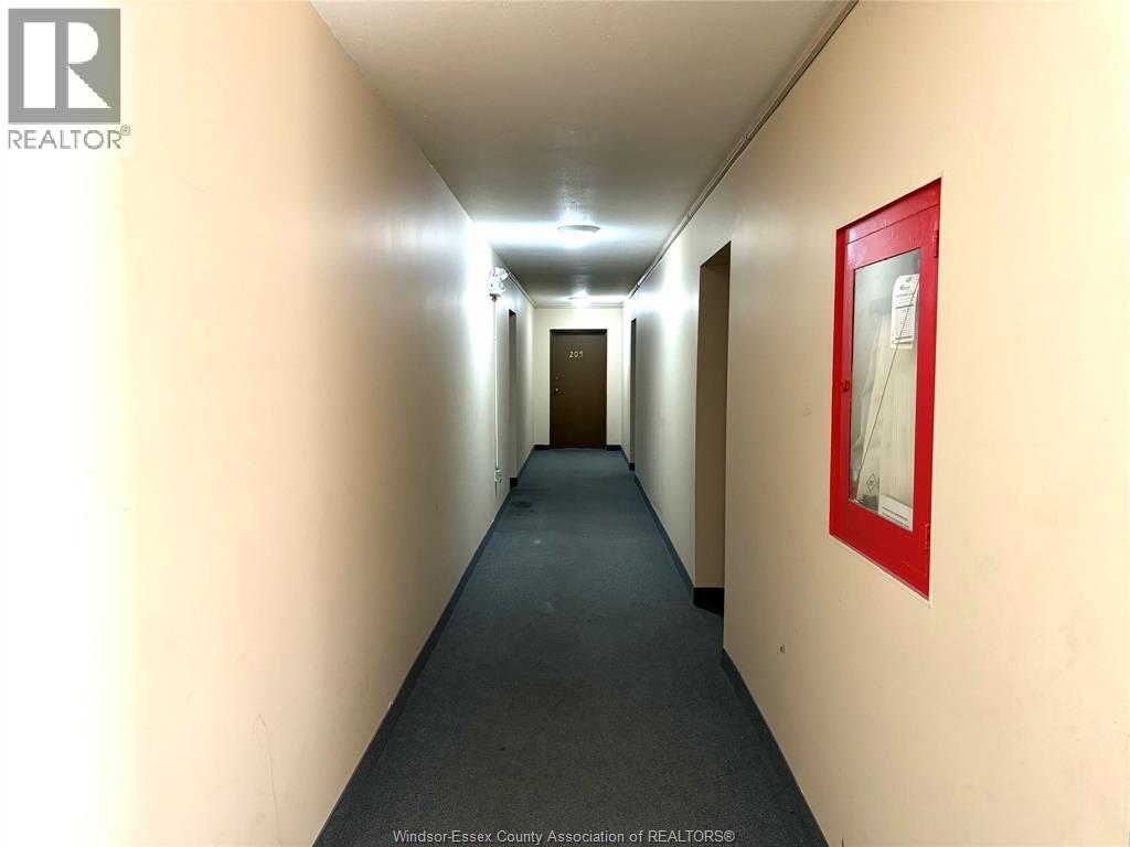 A hallway with a red framed picture on the wall.