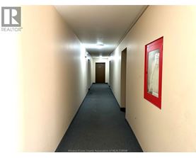 A hallway with a red framed picture on the wall.