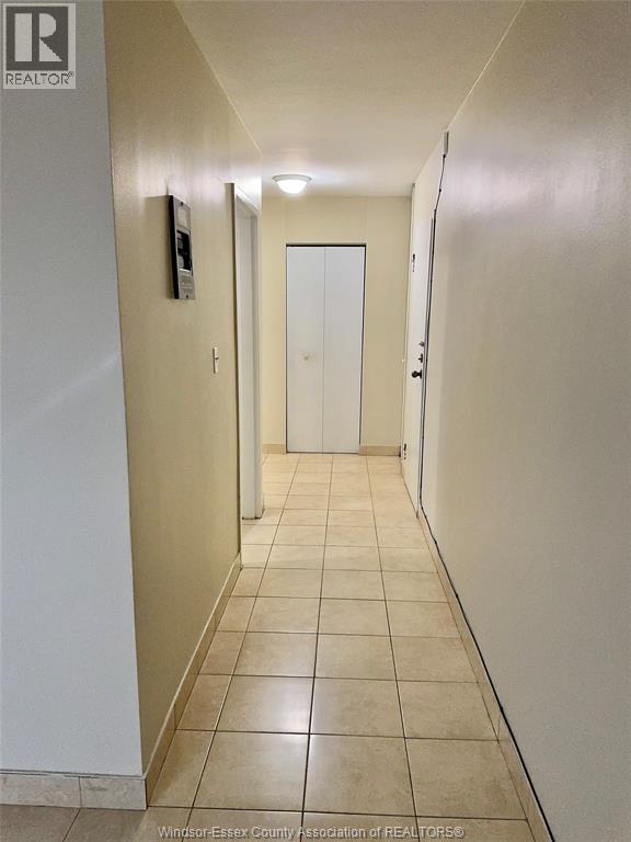A hallway with a door at the end.