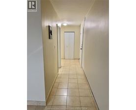 A hallway with a door at the end.