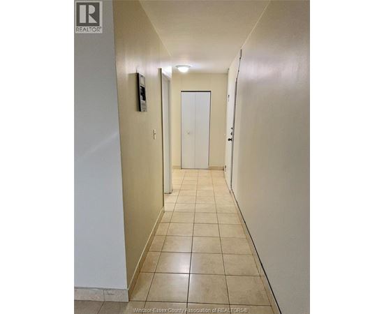 A hallway with a door at the end.
