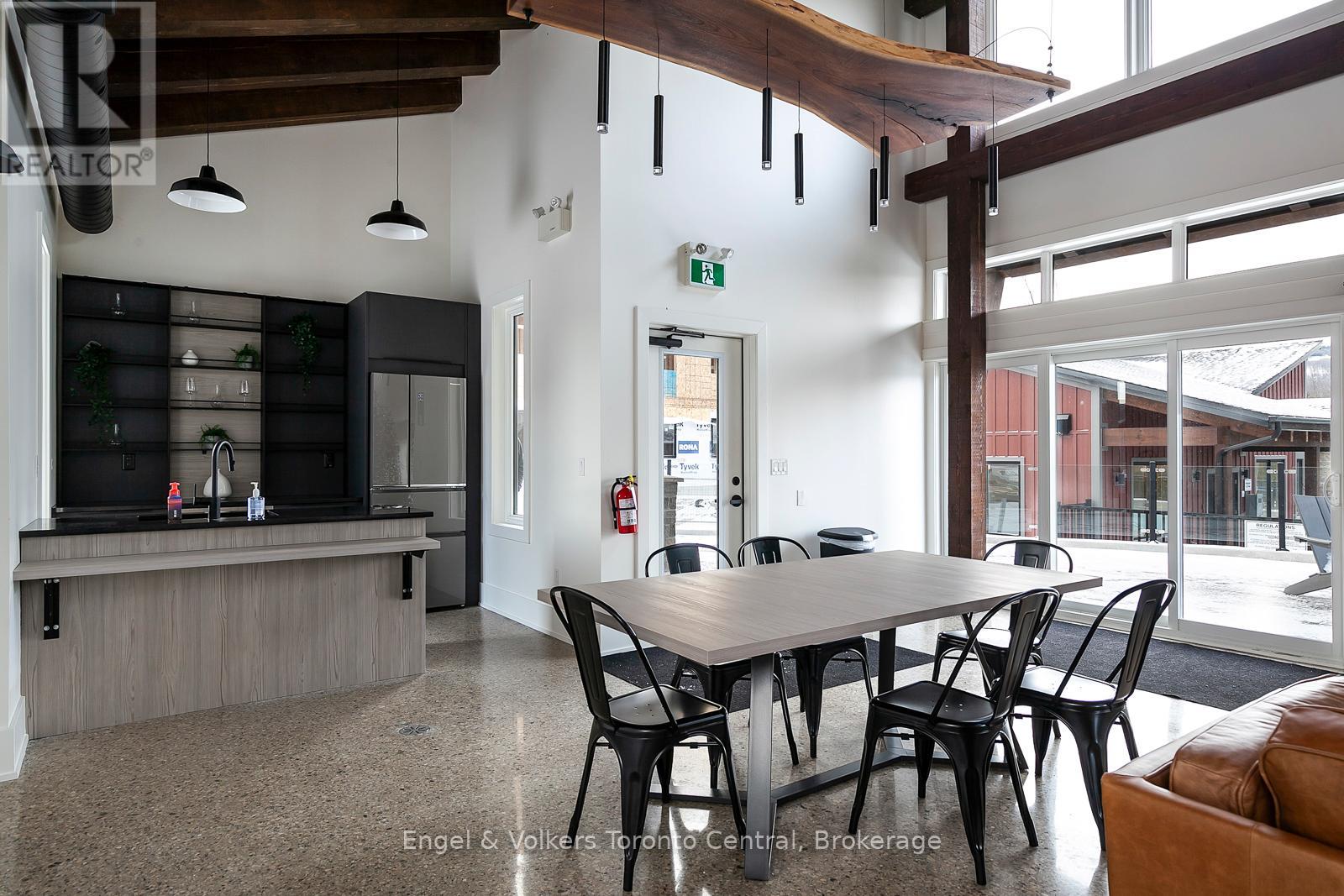 A dining room with a table and chairs.