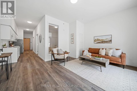 A well-lit living room with a brown couch and a coffee table.
