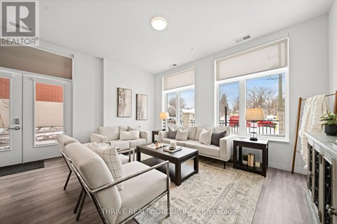 A well-lit living room with a sofa set and a coffee table.