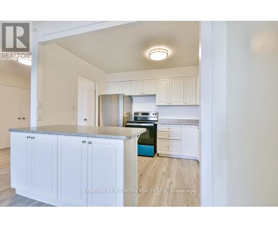 A kitchen with white cabinets and a blue island.
