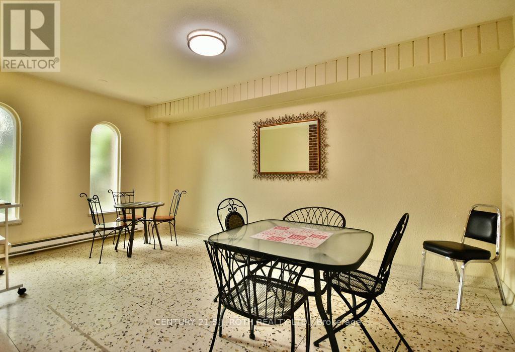 A dining room with a table set for four.