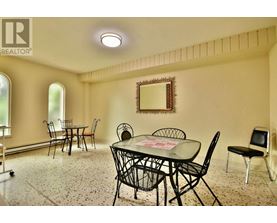 A dining room with a table set for four.