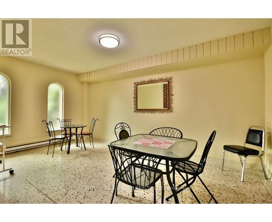 A dining room with a table set for four.