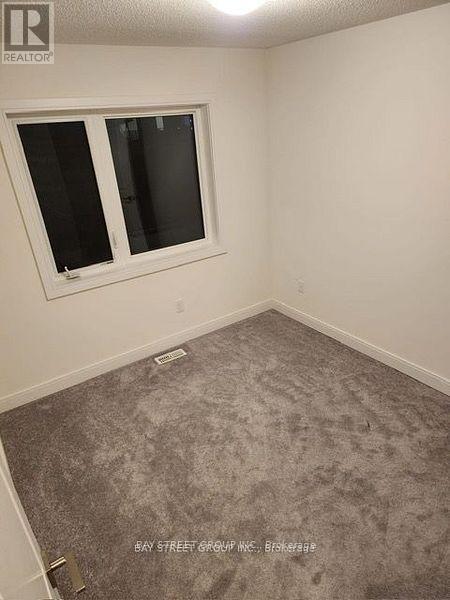 A room with a carpeted floor and a window.