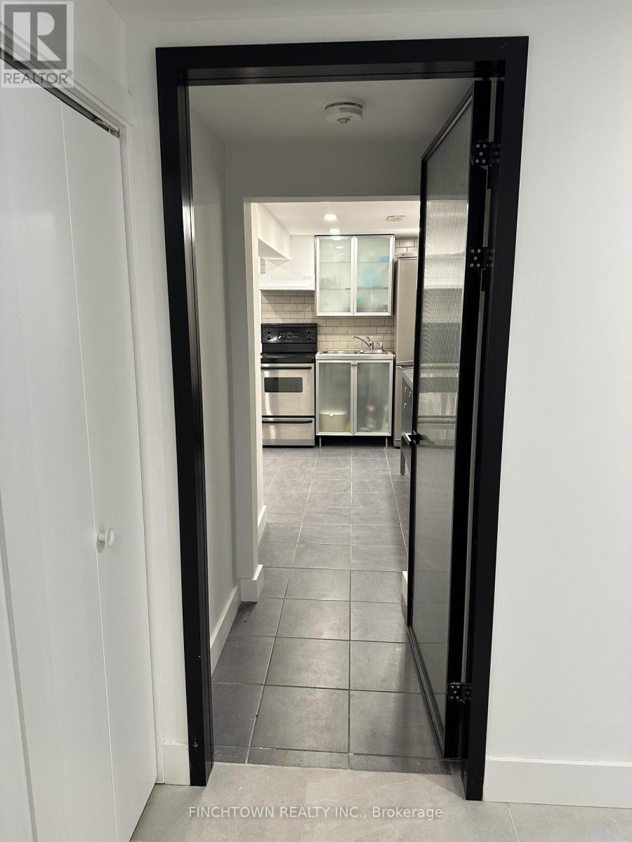A black doorway opens to a kitchen.