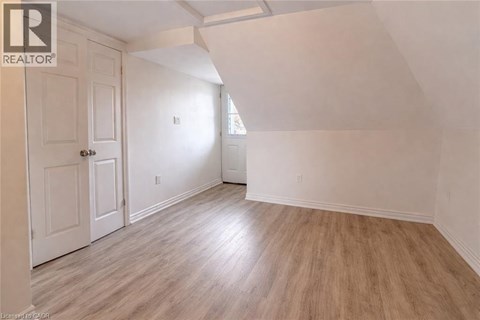 A room with a wooden floor and white walls.
